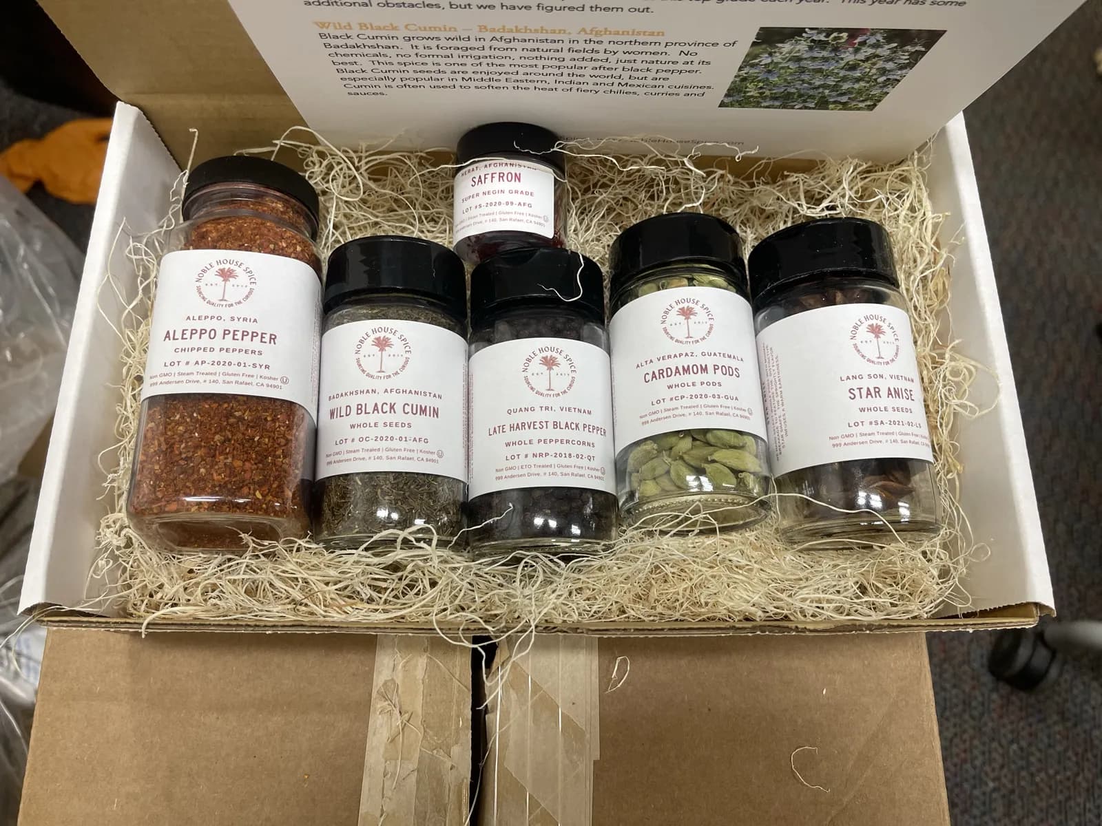 A Noble House Spice sample box with labeled jars of single-origin spices